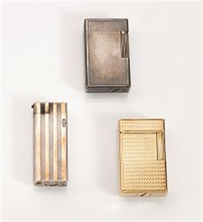 Quattro accendini da tasca in argento ed oro giallorispettivamente: due...