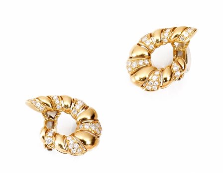 Paio di orecchini in oro giallo e diamanticiascuno modellato come una voluta...