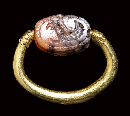 A Greek archaic agate scarab seal set in a swivel gold ring. Griffin.  6th century B.C.