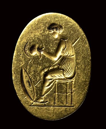 A fine classical greek engraved gold ring. Seated Athena with weapons.  Late 5th - early 4th century B.C.
