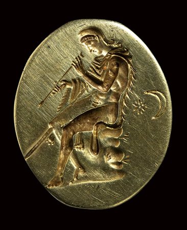 A fine electrum greek ring.  Paris seated with an harrow.  Late 4th century B.C.