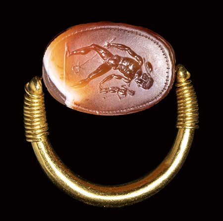 A fine etruscan banded agate scarab intaglio set in a swivel gold ring. Hermes Psychopomp.<br><br>4th century B.C.