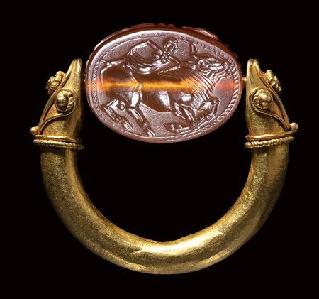 An etruscan carnelian engraved scarab set in a gold swivel ring. Europa with Zeus as bull.<br><br>Late 5th-early 4th century B.C.