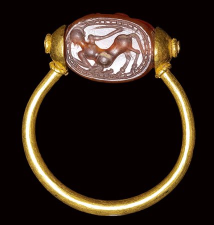 An etruscan carnelian scarab  set in a gold swivel ring. Centaur.  4th century B.C. 