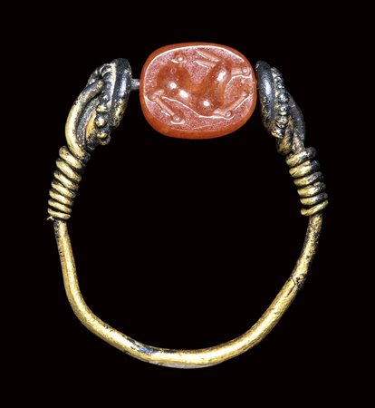 A small etruscan carnelian scarab mounted in a gold ring. Antelope.  3rd century B.C.