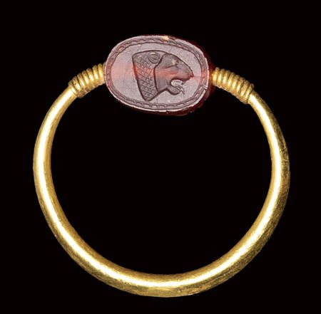 A rare small Phoenician carnelian scarab  set in a gold swivel ring. Lion head.<br><br>6th century B.C, circa 500 B.C.