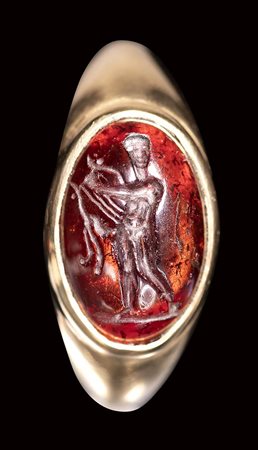 An hellenistic garnet intaglio set in a gold ring. Apollo. 2nd century B.C.