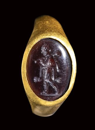 A late italic garnet intaglio set in a gold ring. Omphale. <br><br>2nd - 1st century B.C.
