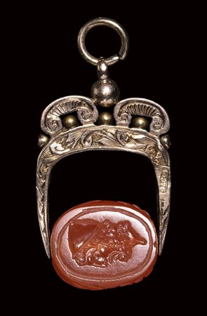 A late italic carnelian engraved scarab set in a 19th century gold mounting. Head of Ulysses. 2nd century - 1st century B.C.