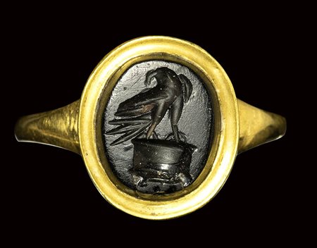 A roman obsidian intaglio mounted on a modern gold ring. Eagle on altar. 2nd century A.D. 