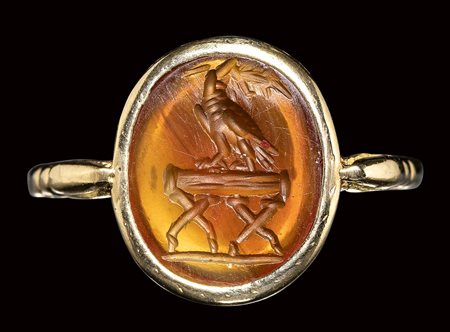 A roman carnelian intaglio mounted on a modern gold ring. Eagle on a stand. 2nd century A.D. 