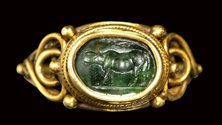 A roman green chalcedony intaglio set in a gold ring. Heafer under a tree.<br><br>2nd century A.D.