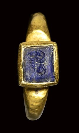 A late roman gold ring set with a lapis lazuli intaglio. Scorpio. <br><br>3rd century A.D.