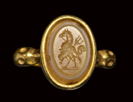 A roman three-layered agate intaglio set in a gold ring. Gryllos.<br><br>3rd century A.D.