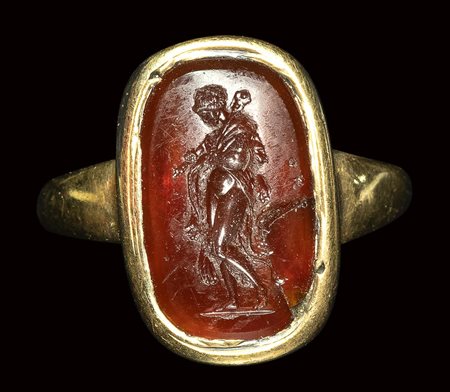 A fine early roman carnelian intaglio set in a gold ring. Omphale.<br><br>1st century B.C.