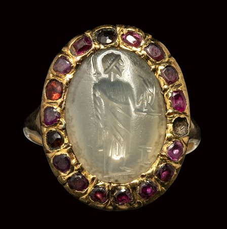 A roman chalcedony intaglio mounted on a 19th century gold ring set with garnets or spinels. Zeus.<br><br>2nd - 3rd century A.D.