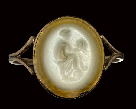 A roman two-layered agate intaglio mounted on an early 19th century gold ring. Muse with mask. 1st century A.D.