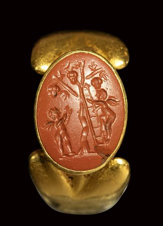 A fine roman red jasper intaglio set in a gold ring. Grape harvest scene with Erotes.<br><br>1st - 2nd century A.D.