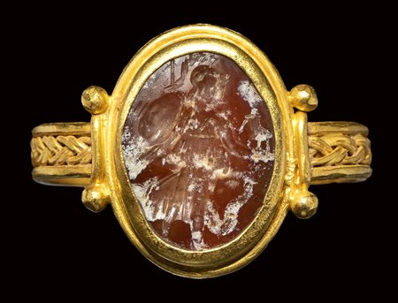 A late roman gold ring set with a burnt agate intaglio. Athena nikephora. 3rd century A.D.