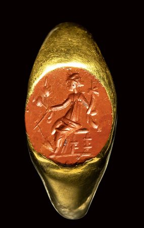 A roman gold ring set with a red jasper intaglio. Fortuna-Tyche. 2nd century A.D.