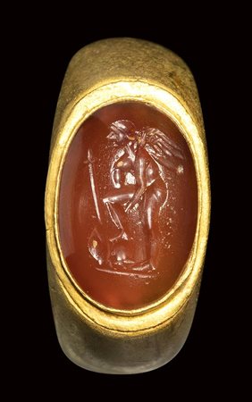 A roman gold ring with carnelian intaglio. Eros with weapons. 1st - 2nd century A.D.