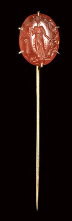 A roman carnelian intaglio set in a gold stick pin. Female figure with attributes. 1st century A.D.