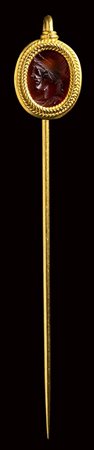 A roman carnelian intaglio set in a gold stick pin. Apollo. <br><br>2nd century A.D. 