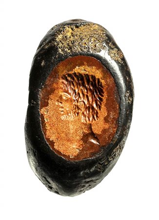 A roman imperial burnt jasper intaglio set in an iron ring. Male bust. <br><br>Late 2nd century A.D.