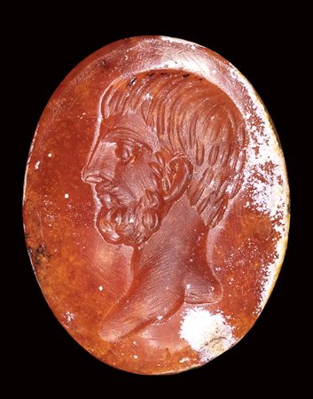 A roman burnt carnelian intaglio. Male portrait. <br><br>2nd century A.D.