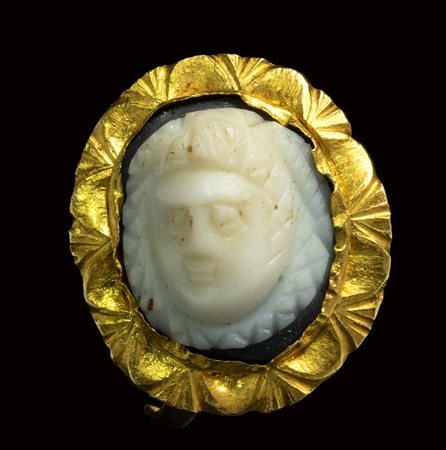 A roman onyx cameo set in a gold ring. Frontal mask of Medusa. <br><br>3rd century A.D.