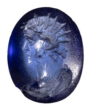A roman blue glass intaglio. Portrait of Helios. <br><br>2nd century A.D.