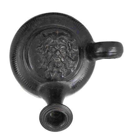 APULIAN BLACK-GLAZED GUTTUS ca. 300 BC height cm 12 With a fronting head of a...