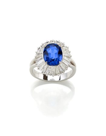 Anello in oro e platino con diamanti tapered a contornare uno zaffiro ovale di