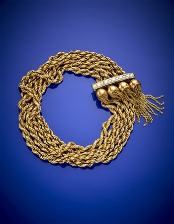Bracciale a più fili di catena inanellata con nappe e fermo in oro bianco e dia