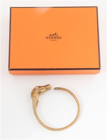 HERMÈS Bracciale Galop in metallo dorato raffigurante testa di cavallo. Anni...