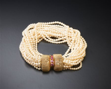  . - Bracciale " liberty" con perline oro 14 carati e piccoli rubini.