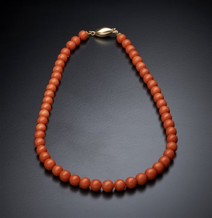  . - Filo di corallo rosso a pallini sferici con chiusura in oro giallo 750/1000 ovale bombata.