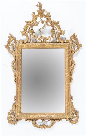 Specchiera in legni di cirmolo intagliato e dorato in stile del XVIII secolo....