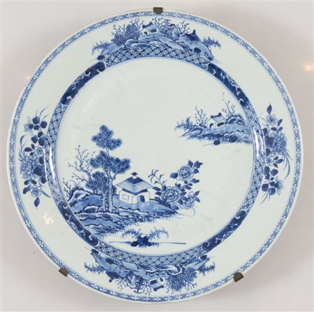 Grande vassoio in porcellana monocroma blu con pagode e paesaggi fantastici. Cina, XVIII secolo. Diametro cm 34,4. (sbeccature visibili lungo il bordo)