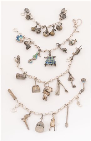 Lotto composta da quattro bracciali in argento con charmes. Peso complessivo:...