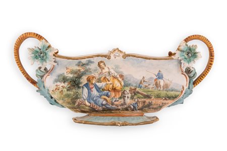 Fedele Cappelletti (Rapino, 1847 - Rapino, 1920) 
Giardiniera in maiolica decorata con elementi fitomorfi a rilievo ed istoriata con una scena agreste di gusto neo rococò 
 cm 23,5x52