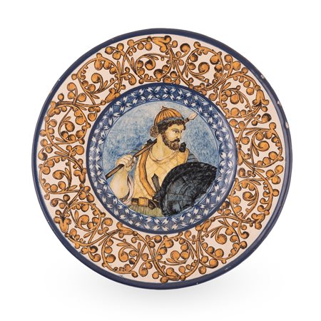 Manifattura dell'Italia centrale dell'ultimo quarto del XIX secolo ( - ) 
Piatto in maiolica decorato sulla tesa con girali fitomorfi e nel cavo, con la figura di un'antico guerriero 
 Ø cm 32