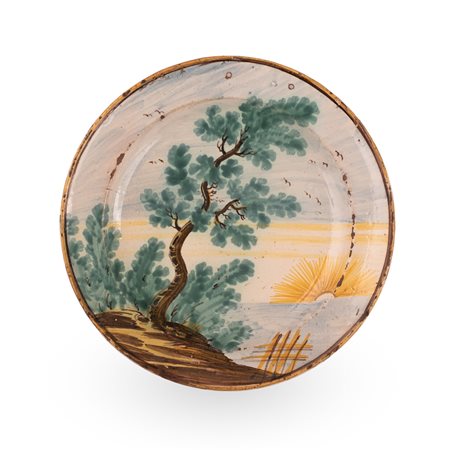 Manifattura di Torre de' Passerii attivo nel XVIII secolo ( - ) 
Piatto in maiolica decorato con paesaggio e scorcio lacustre. 
 Ø cm 23