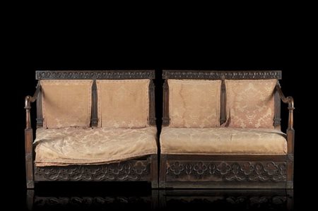 Coppia di panchetti in stile neogotico intagliati a rosoni con braccioli mossi,