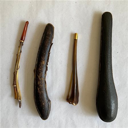 Lotto composto da due bocchini in osso con ghiere in oro. In custodie (difetti)