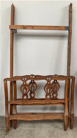 Lettino di forma mossa con testata e pediera a cartelle intagliate, sagomate e