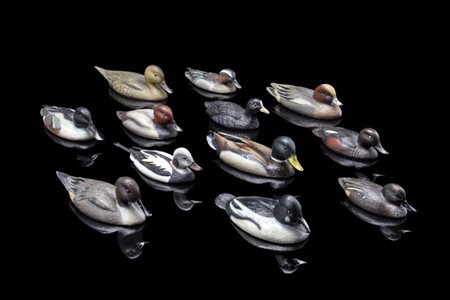 Dodici sculture in argento e smalti in raffiguranti diverse specie di anitre di
