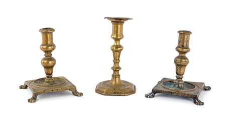 Tre antichi candelieri in ottone diversi