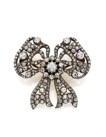 CARTIER 
Spilla a fiocco in oro e argento, diamanti old mine e a mezza rosetta,