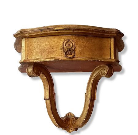 Piccola console da appendere di forma mossa in legno intagliato e dorato e...